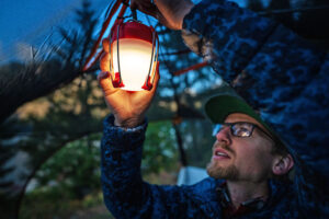 Using LED lanterns for creating cozy ambient lighting in a campsite at night.